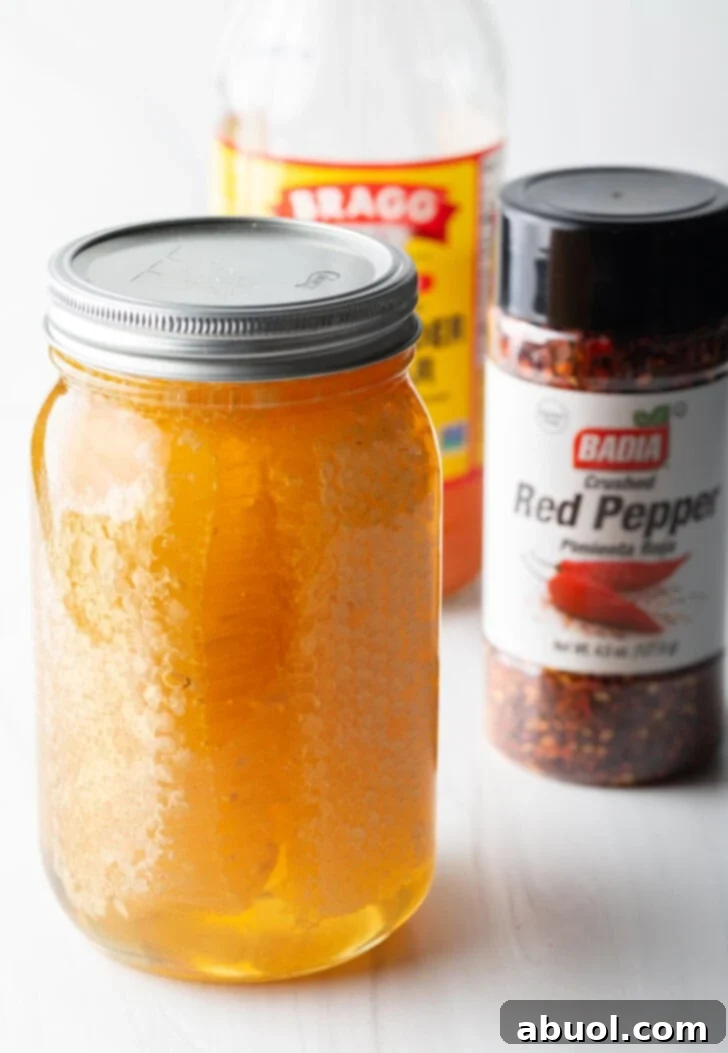 Sweet Heat Honey Blend 5 Recipe ingredients in separate container: jar of honey, shaker of crushed red pepper, bottle of apple cider viegar.