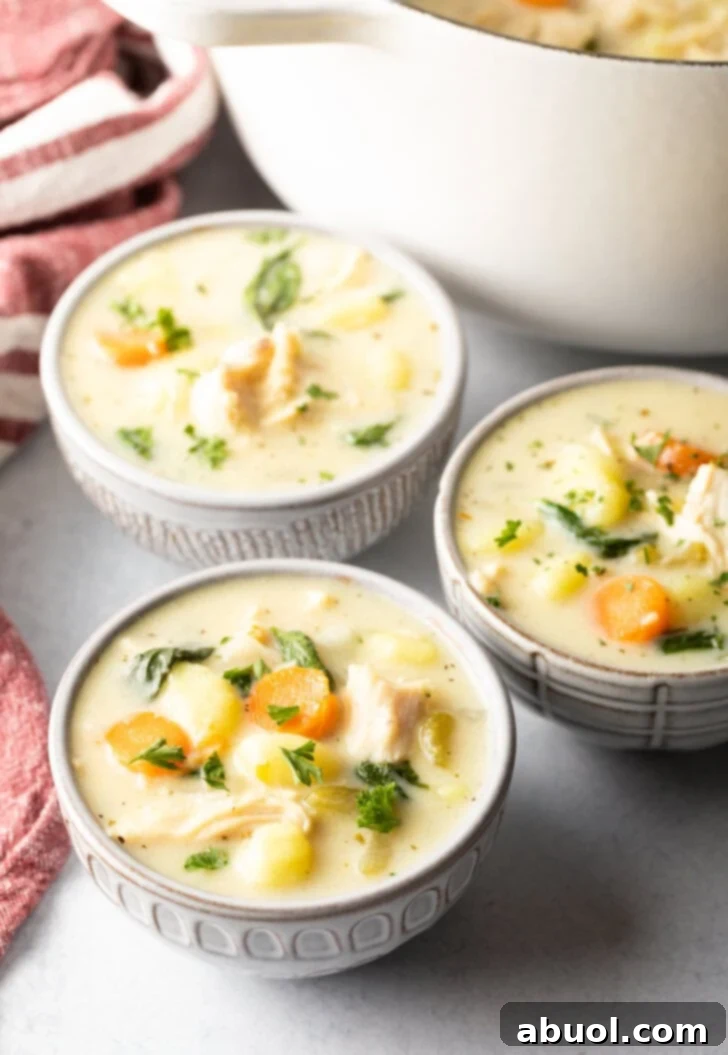 3 white bowls of olive garden chicken gnocchi soup.