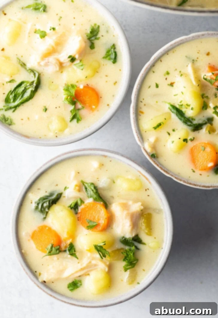 3 white bowls of chicken gnocchi soup.