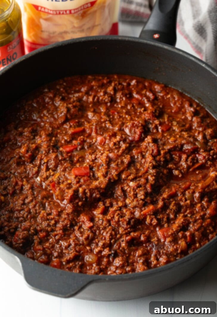 Deep cast iron skillet with homemade chili.