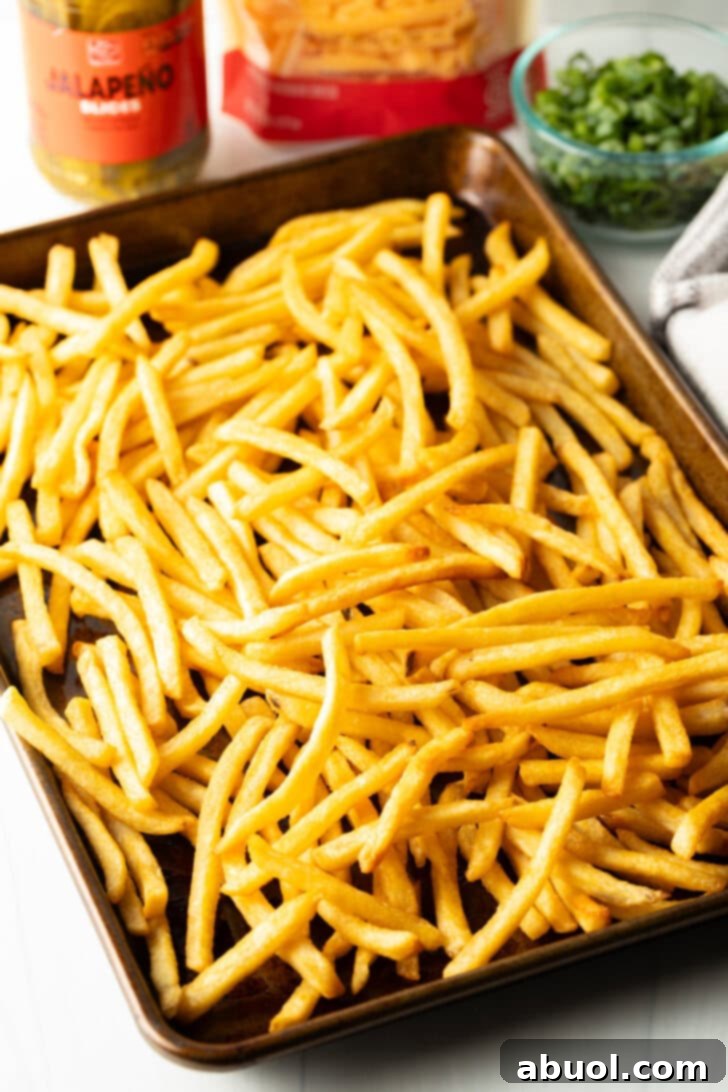 Baking sheet loaded with crispy fries.