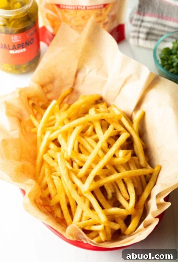 Basket with parchment paper, filled with crispy fries.