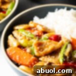 Bowl of American chicken chop suey nestled beside white rice.