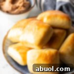Stack of rectangle Texas Roadhouse rolls.