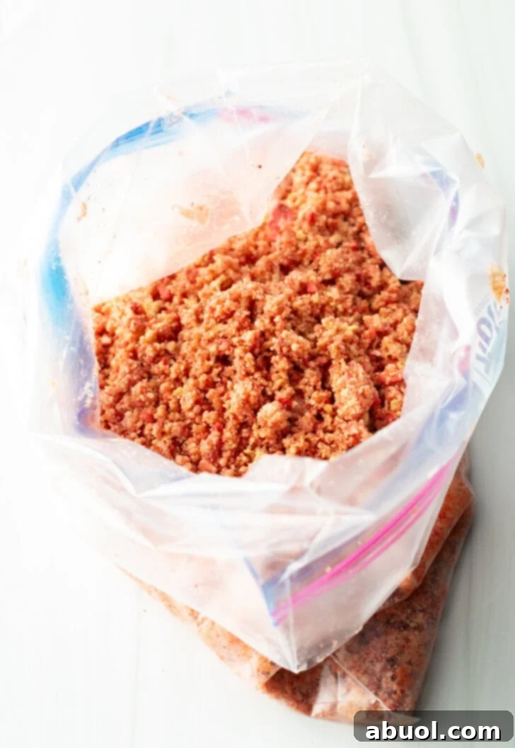 Berry Crumble Bliss Cake 11 A clear plastic ziploc bag filled with perfectly crushed Golden Oreo cookies and freeze-dried strawberries, ready to be transformed into the crunchy cake topping.