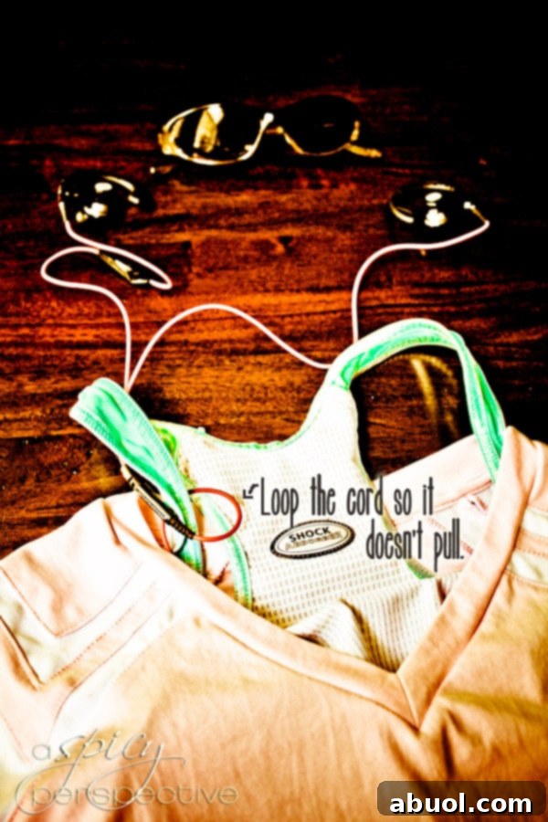 Loop the headphone coard around your sports bra so it doesnt pull 