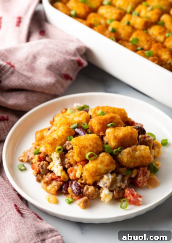 White plate with tater tot and ground beef cowboy casserole.