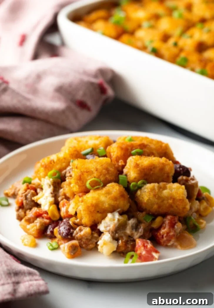 White plate with tater tot and ground beef cowboy casserole.