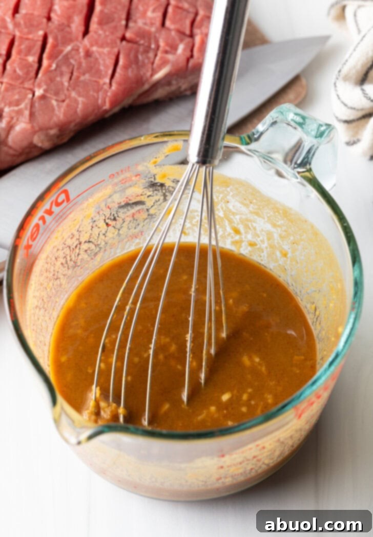Whisk in a glass measuring cup with marinade.