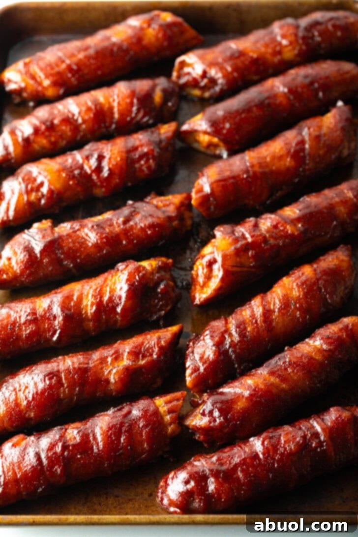 14 bacon wrapped smoked shells on a baking pan.