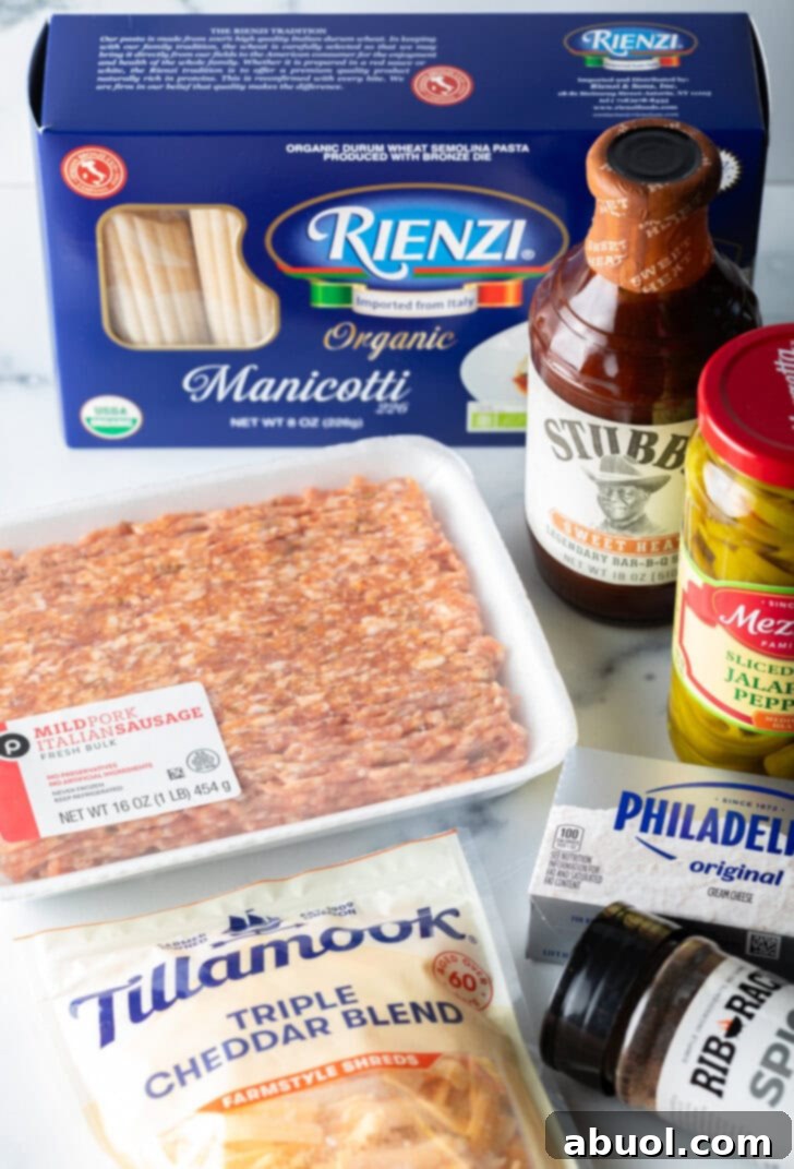 Recipe ingredients: Package of ground meat, bottle of bbq sauce, jar of pepperoncinis, box of manicotti noodles, packages of cream cheese and shredded cheddar cheese.