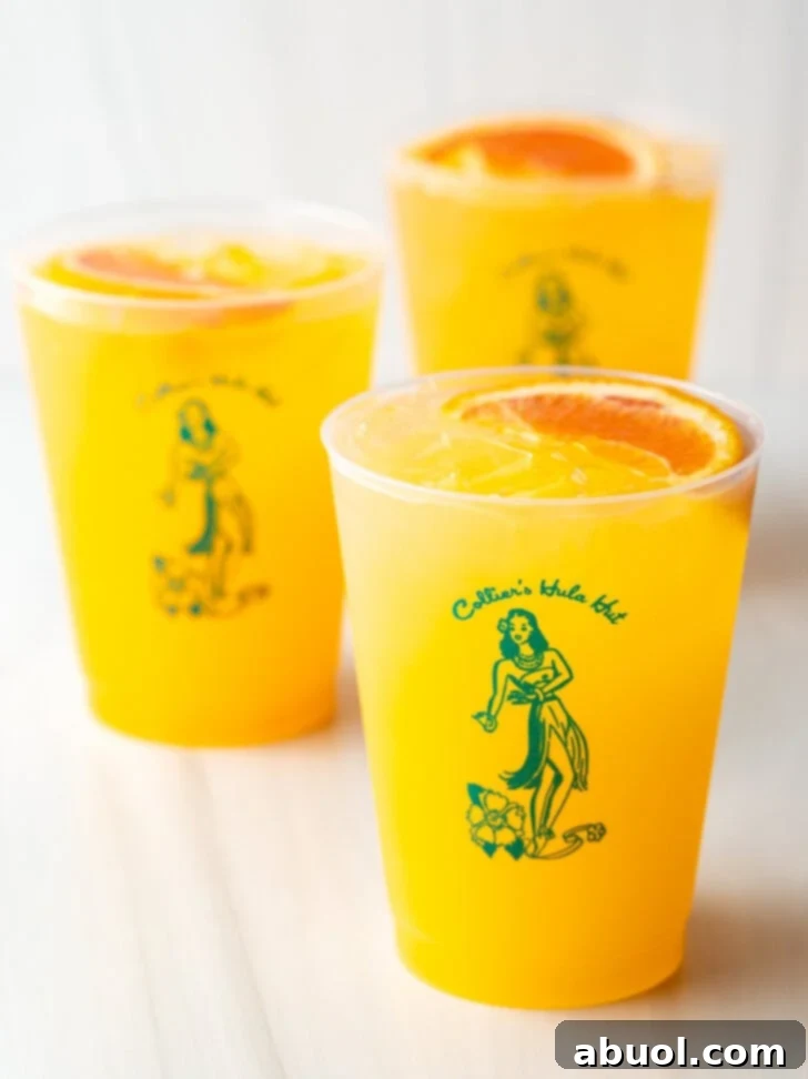 Three Sunny D Vodka Seltzer drinks, each in a glass cup with a fresh orange slice garnish.