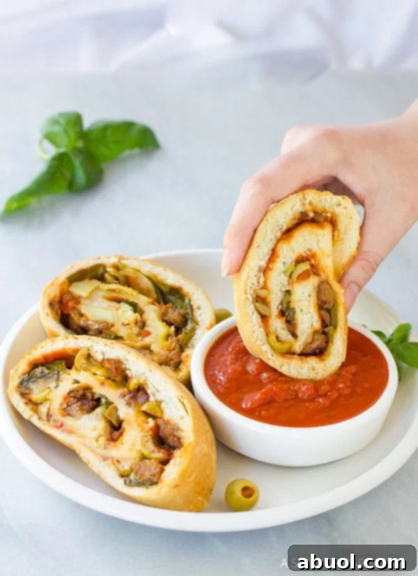 A beautifully sliced homemade Stromboli, ready to eat, with steam gently rising, highlighting the delicious fillings.