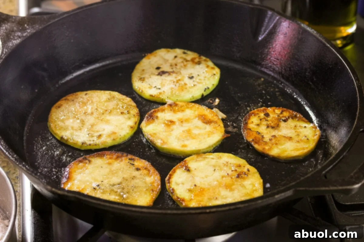 Easy eggplant recipe, showcasing perfectly pan-fried slices ready to be seasoned.