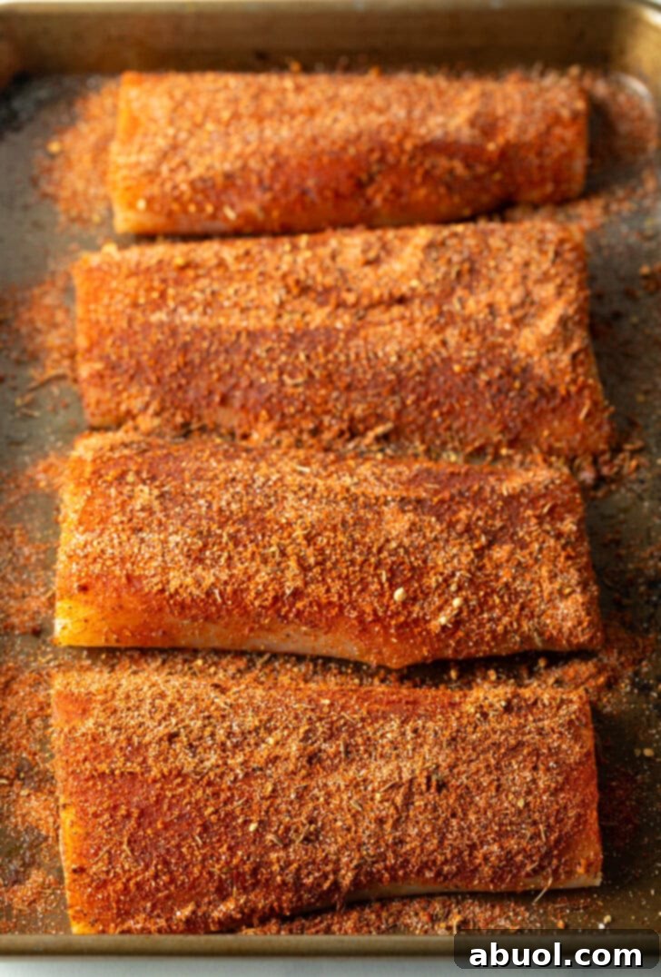 4 pieces of raw fish fillets coated with homemade blackening seasoning.