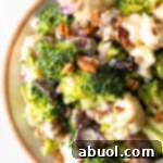 Top down view of broccoli and cauliflower salad in a large bowl