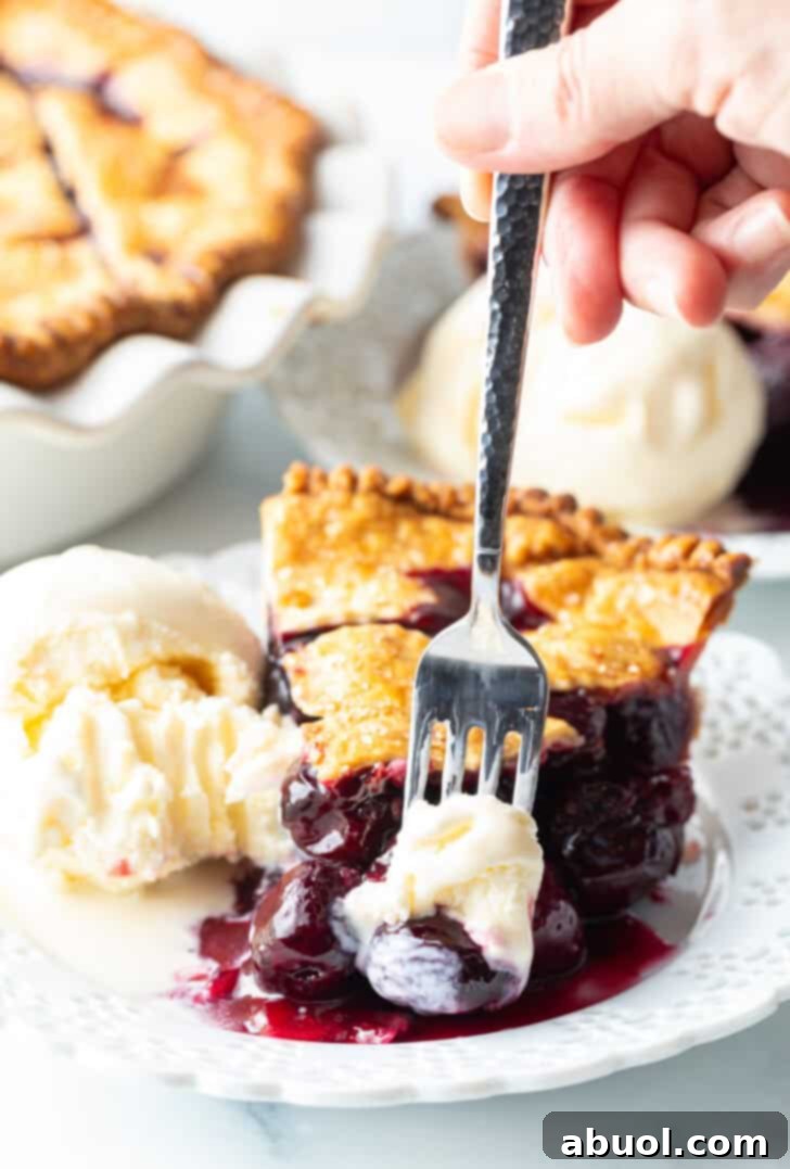 Bite of best Cherry Pie recipe with vanilla ice cream