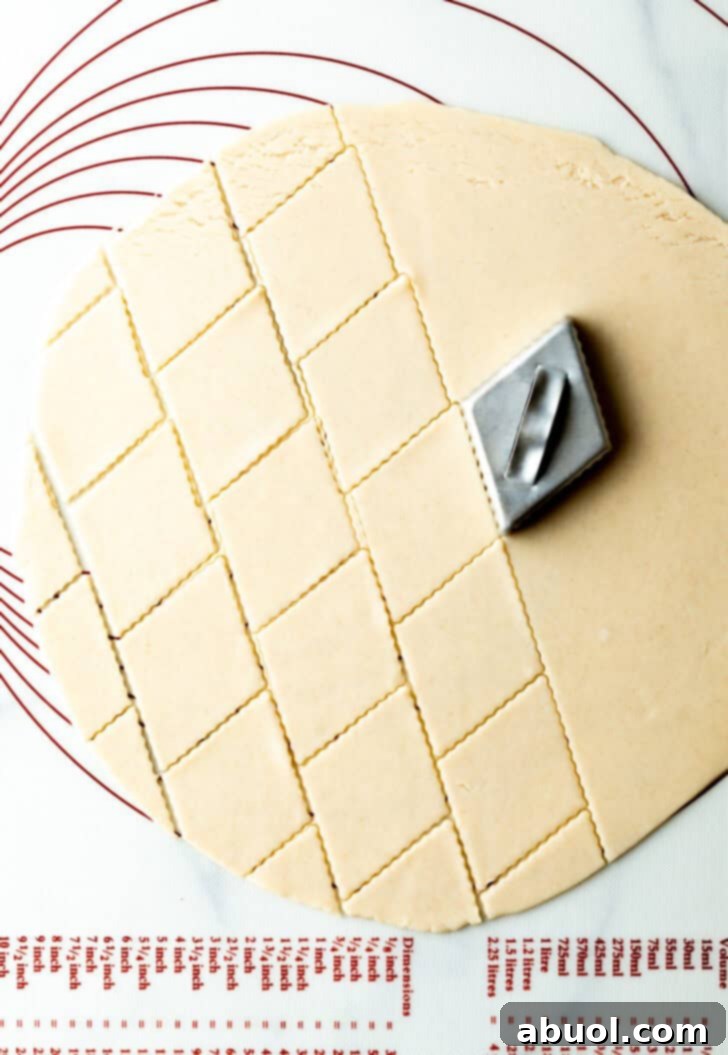Using a diamond stamper to create a pattern in the raw pie dough.