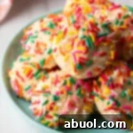 Luscious Cream Cheese Delights 10 Blue plate piled with cookies covered in colorful sprinkles.