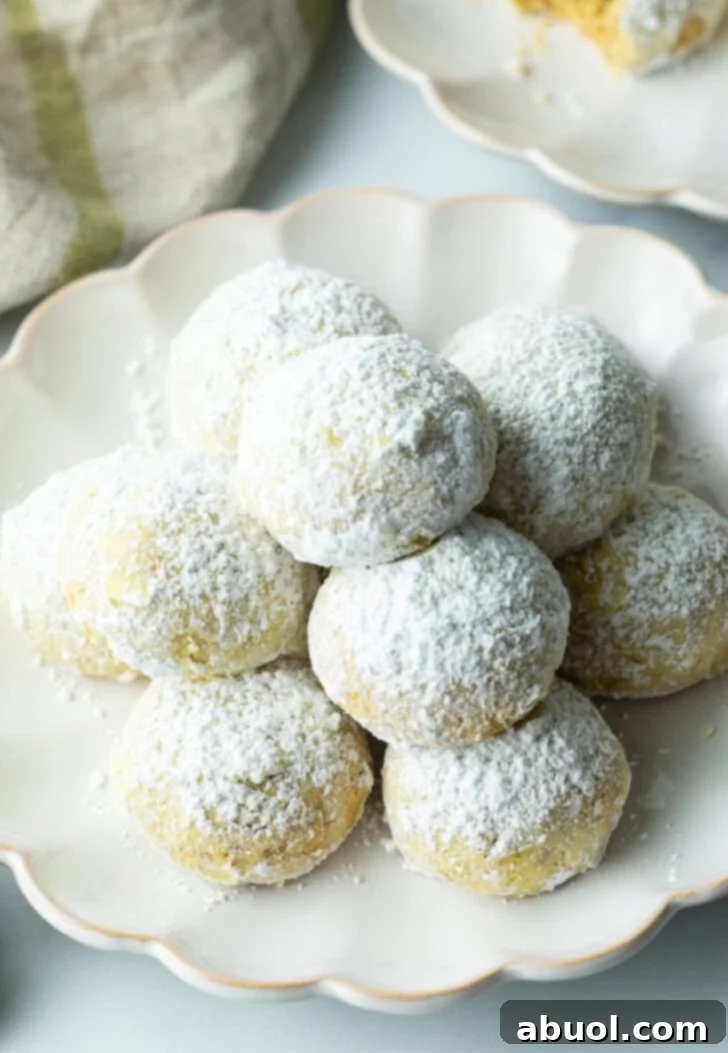Sweet Italian Bridal Bites 11 Pyramid stacks of almond and pistachio Italian wedding cookies dusted with powdered sugar, ready for serving.