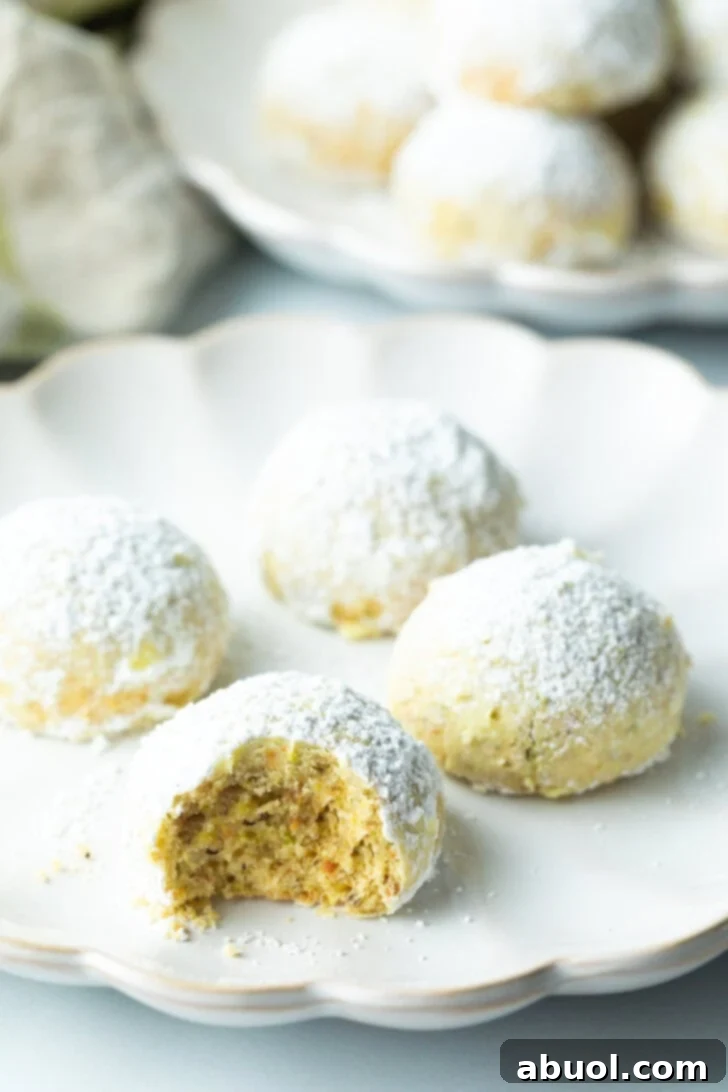 Sweet Italian Bridal Bites 12 Four Italian wedding cookies dusted with powdered sugar, with a bite taken out of the closest cookie.