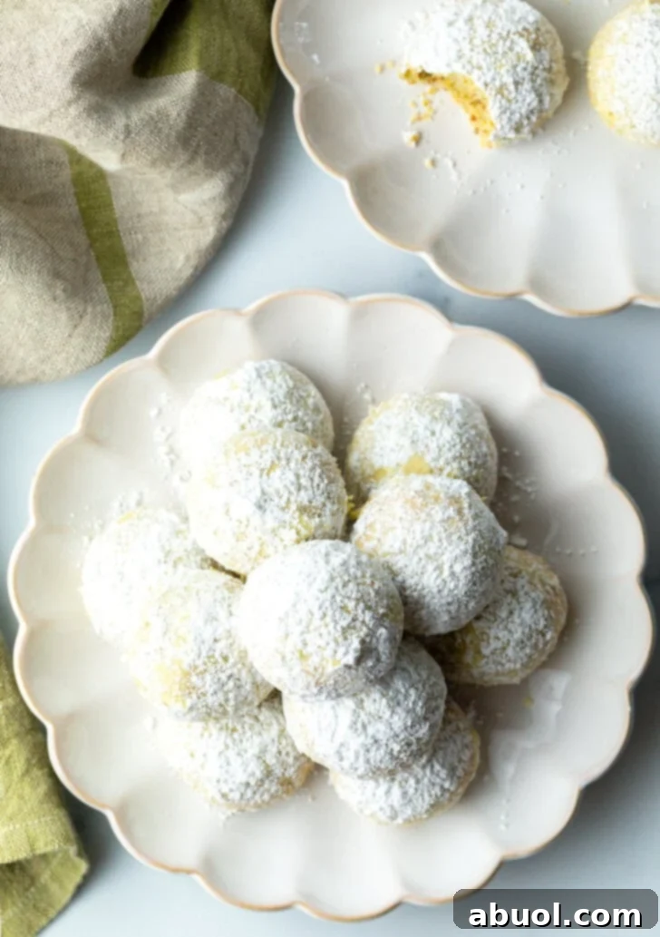 Sweet Italian Bridal Bites 4 Top down view of pyramid stacks of almond and pistachio Italian wedding cookies dusted with powdered sugar.