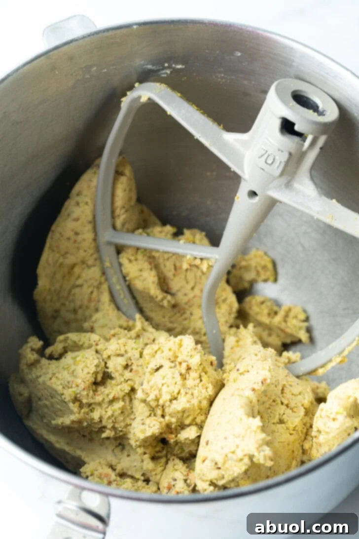 Sweet Italian Bridal Bites 6 Cookie dough in a metal mixing bowl, with mixer paddle in the bowl.
