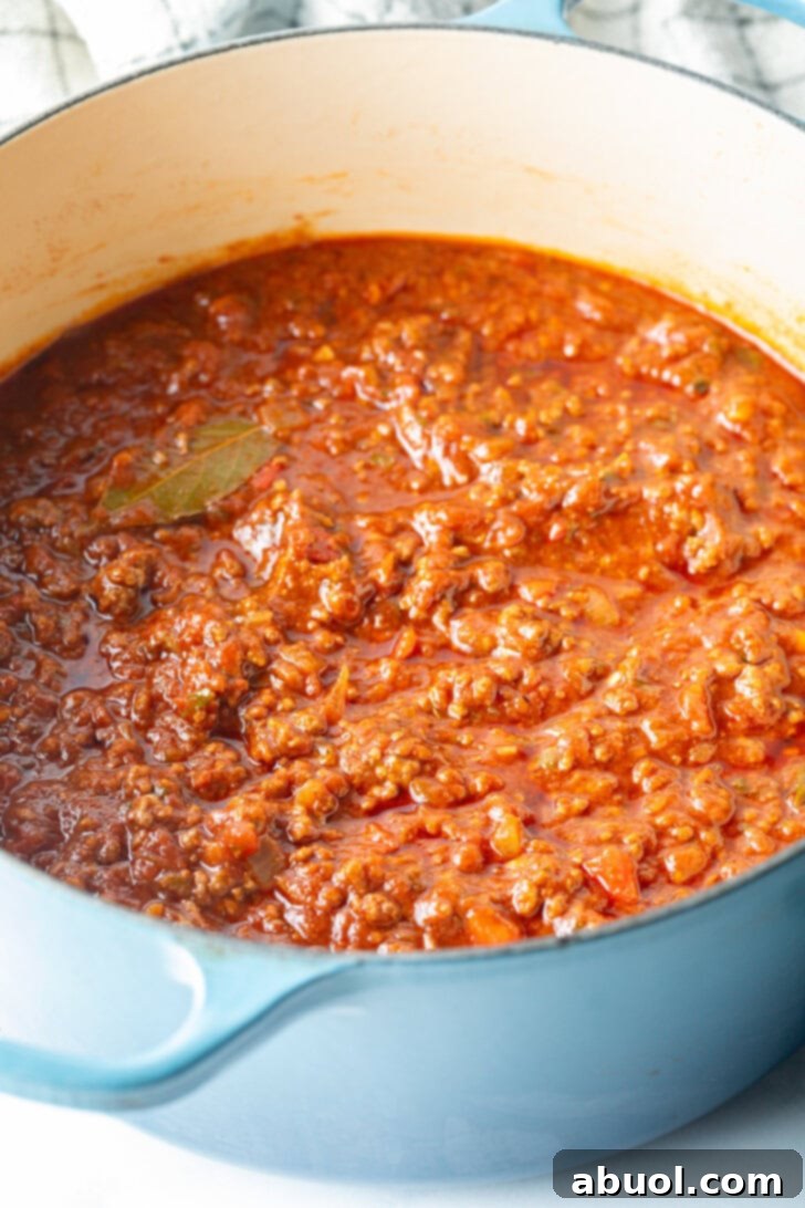 Meaty beef chili in a blue cooking pot.