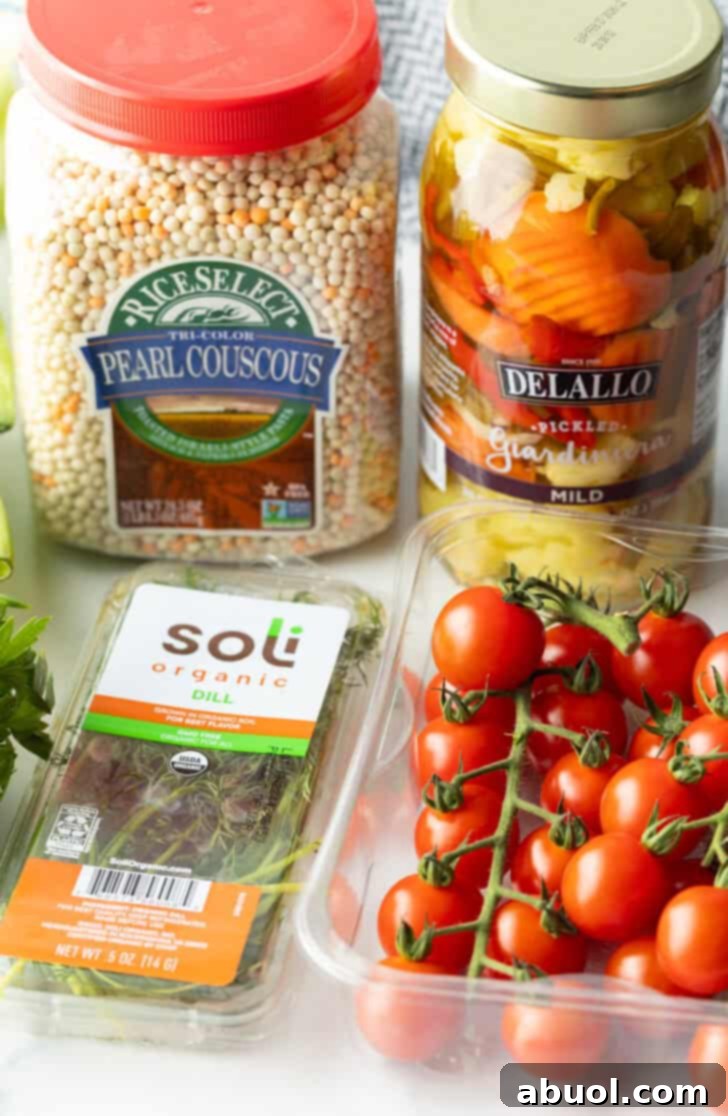 Recipe ingredients in individual containers: Pearl couscous, giardiniera pickled vegetables, on the vine cherry tomatoes, and fresh dill, ready for preparation.