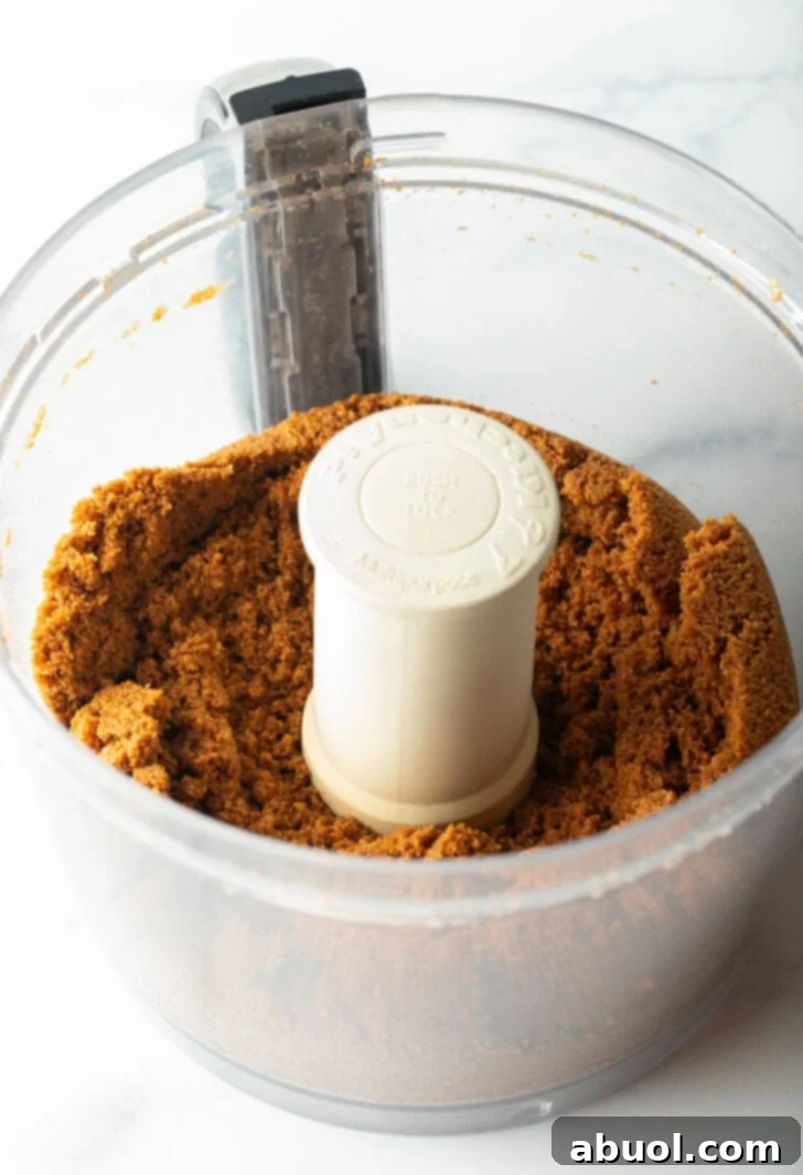 Finely crushed gingersnap cookies in a food processor bowl.