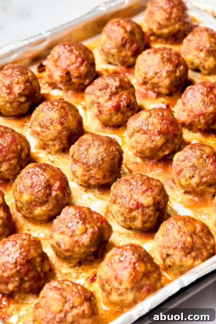 Baked Spiced Apple Cocktail Meatballs Gluten Free Meatballs - baked meatballs on a tray with apple glaze