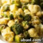 White oval platter loaded with roasted broccoli and cauliflower florets.