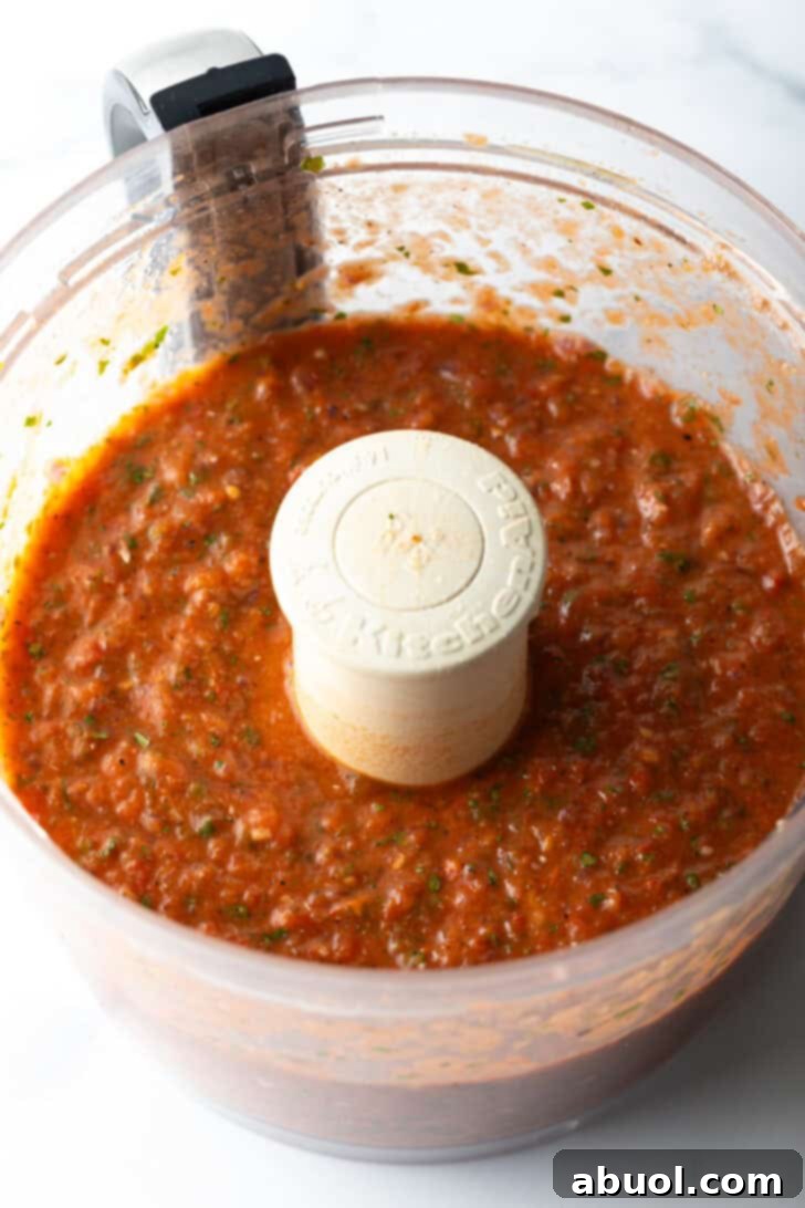 Food processor with fresh tomato salsa.