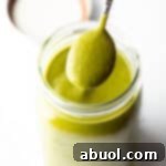 Spoonful of poblano sauce showing to camera.