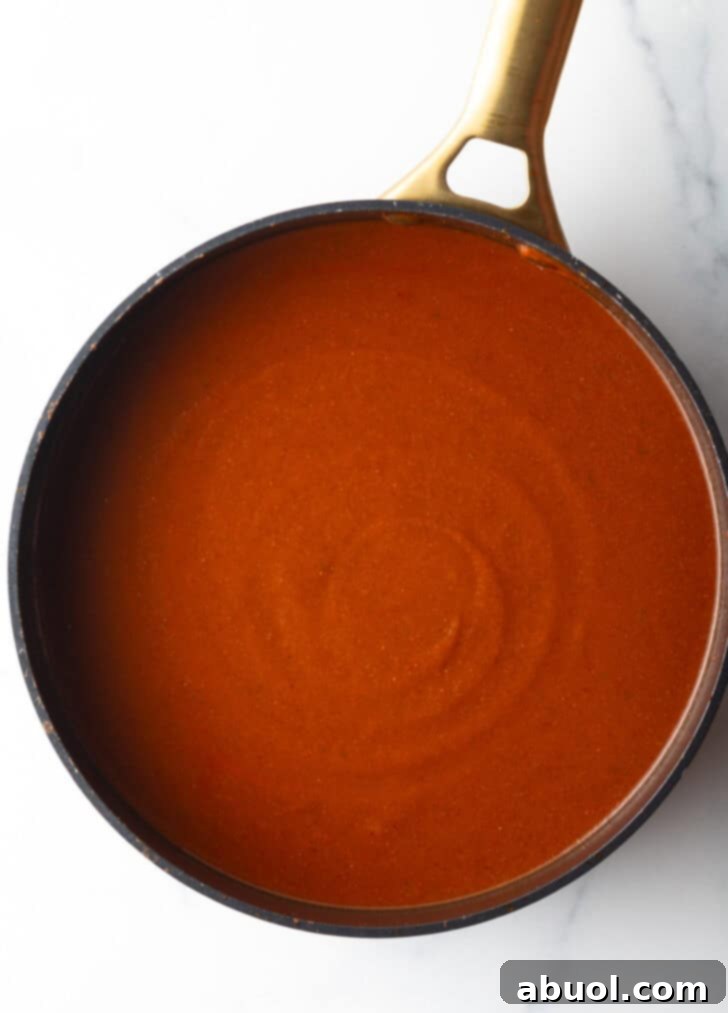 Top down view large deep skillet of red sauce.