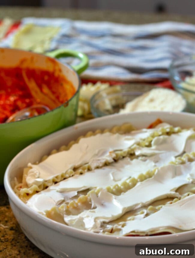 The crucial step of layering pasta and cheese in a baking dish for cream cheese lasagna