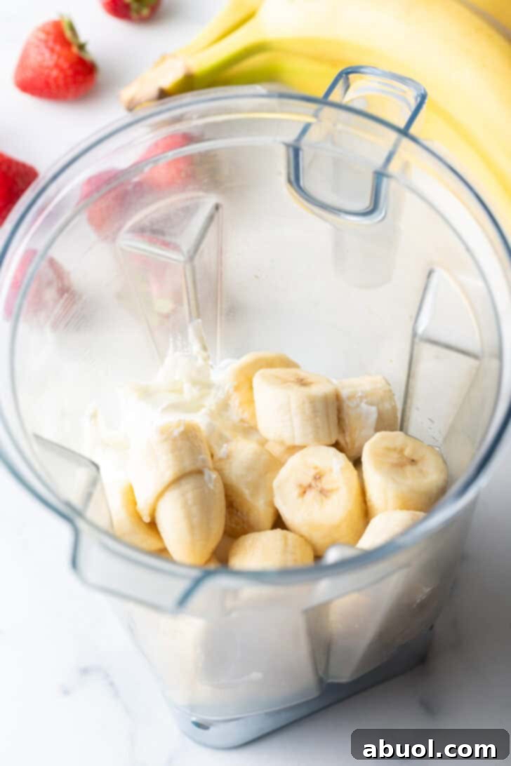 Frozen chunks of banana in a blender jar.