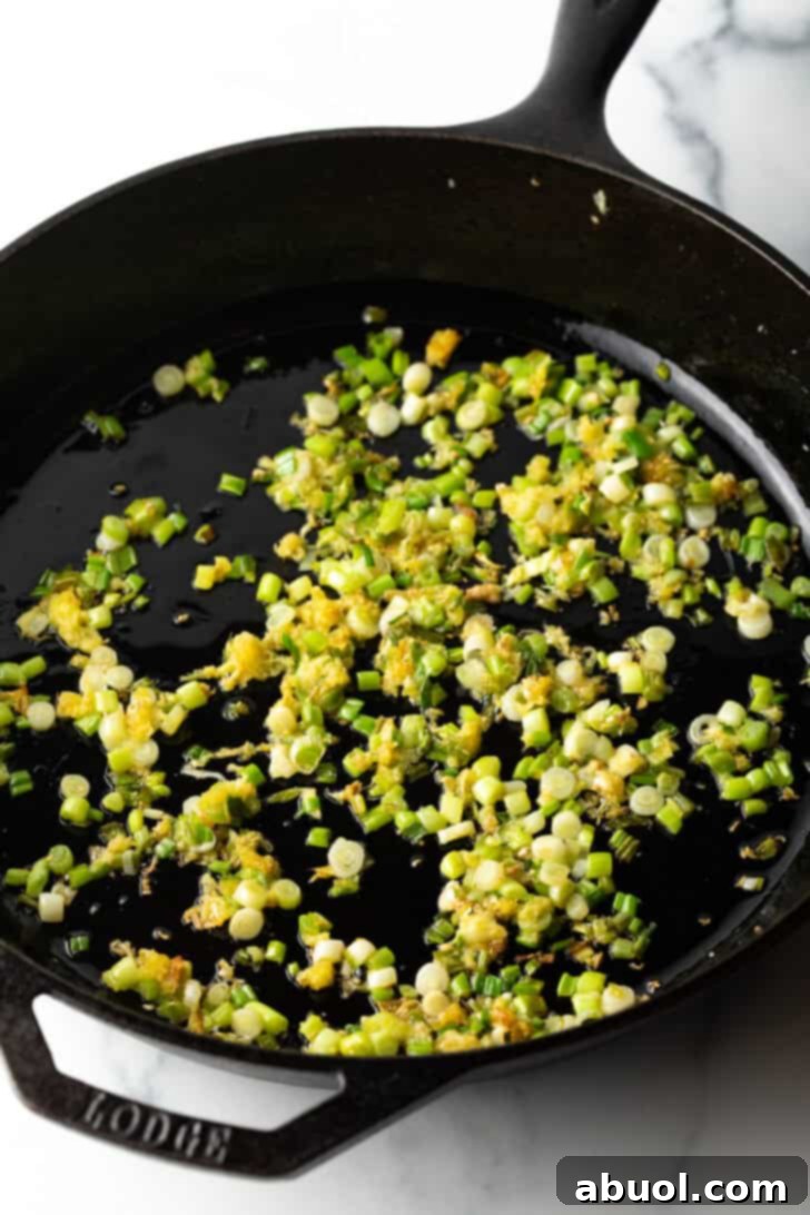 Fragrant Thai Crab Fried Rice 6 Sauteeing scallion white and grated ginger in a cast iron skillet.