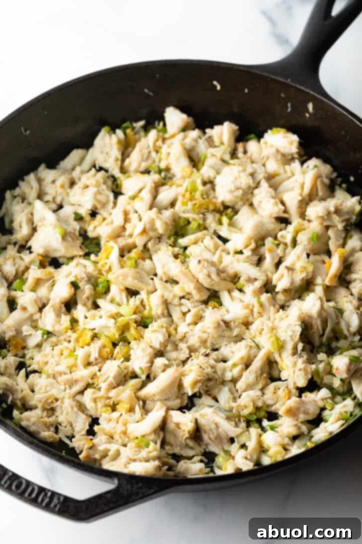 Fragrant Thai Crab Fried Rice 7 Large chunks of crab meat cooking in a black cast iron skillet.