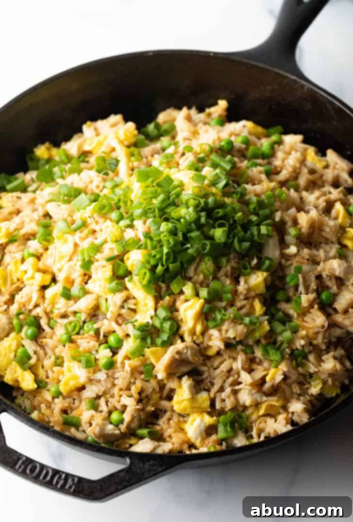 Fragrant Thai Crab Fried Rice 10 Adding green scallions to a skillet of crab meat and fried rice.