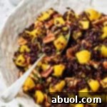 Black Rice Recipe in white bowl with spoon and butternut squash
