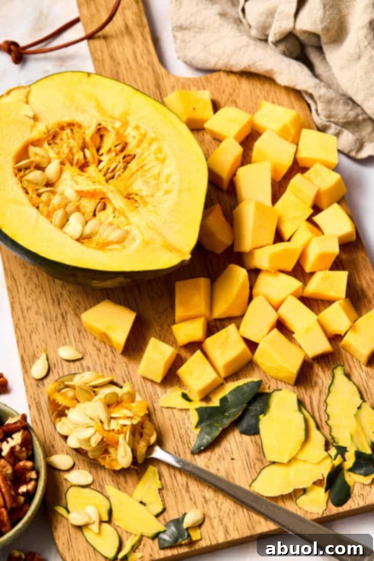 A selection of raw ingredients including butternut squash, pecans, shallots, and fresh herbs, prepped for cooking.