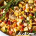 A large white pot brimming with chicken minestrone soup and fresh sprigs of rosemary, showcasing a delicious meal.