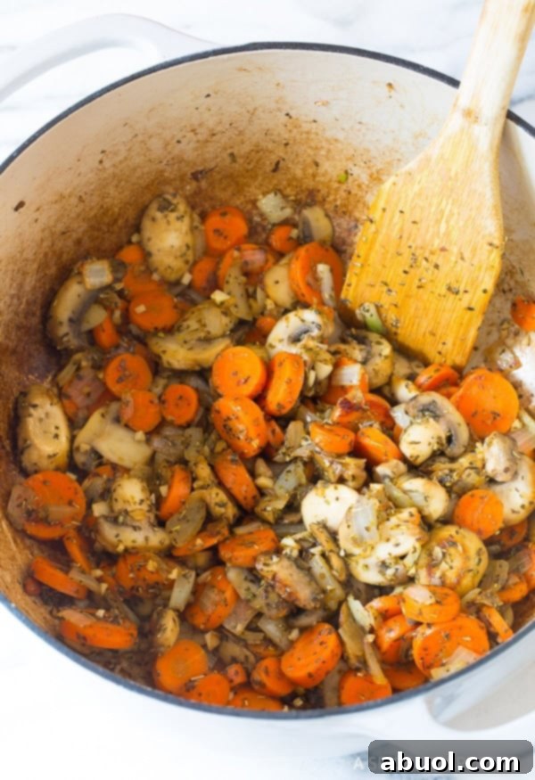 A vibrant close-up of healthy chicken minestrone soup, highlighting the fresh vegetables and rich broth.