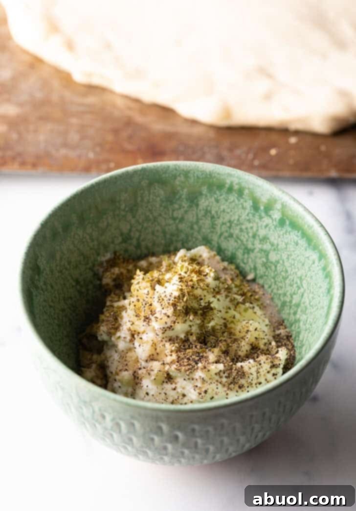 White sauce ingredients in a green bowl.