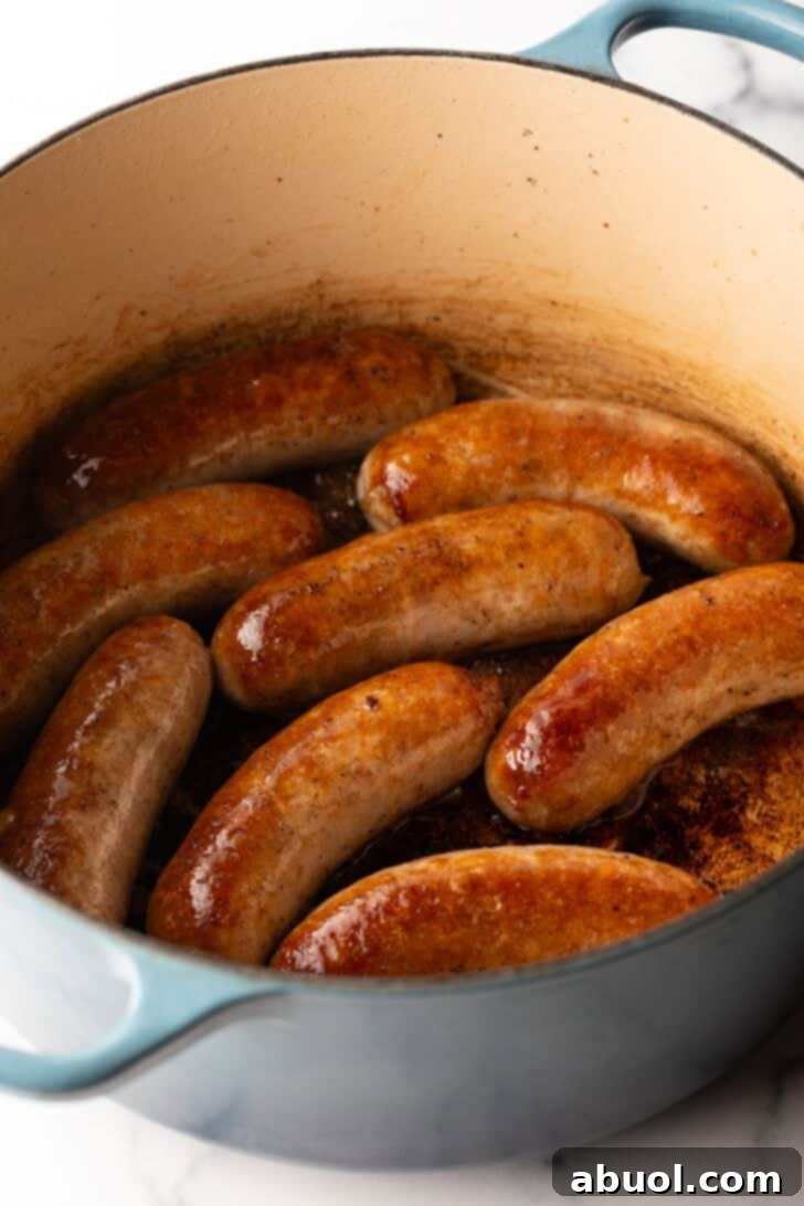 Large cooking pot with 8 seared Italian sausages.