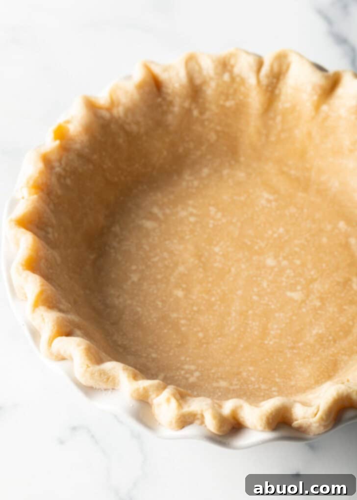 A perfectly blind-baked empty pie crust, golden brown and ready for a delicious no-bake filling.