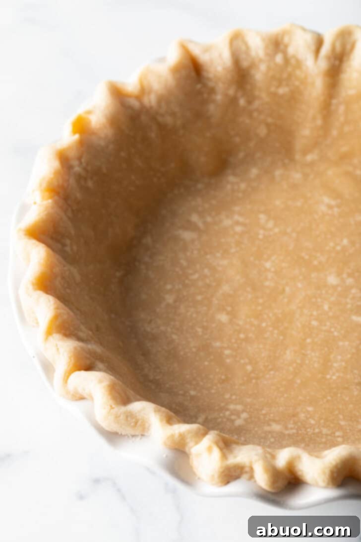A perfectly baked, empty pie crust, golden brown and ready for filling, showcasing its ideal texture.