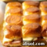 Sweet Hawaiian Bites 14 A dozen King's Hawaiian ham and cheese sliders with a golden glaze.