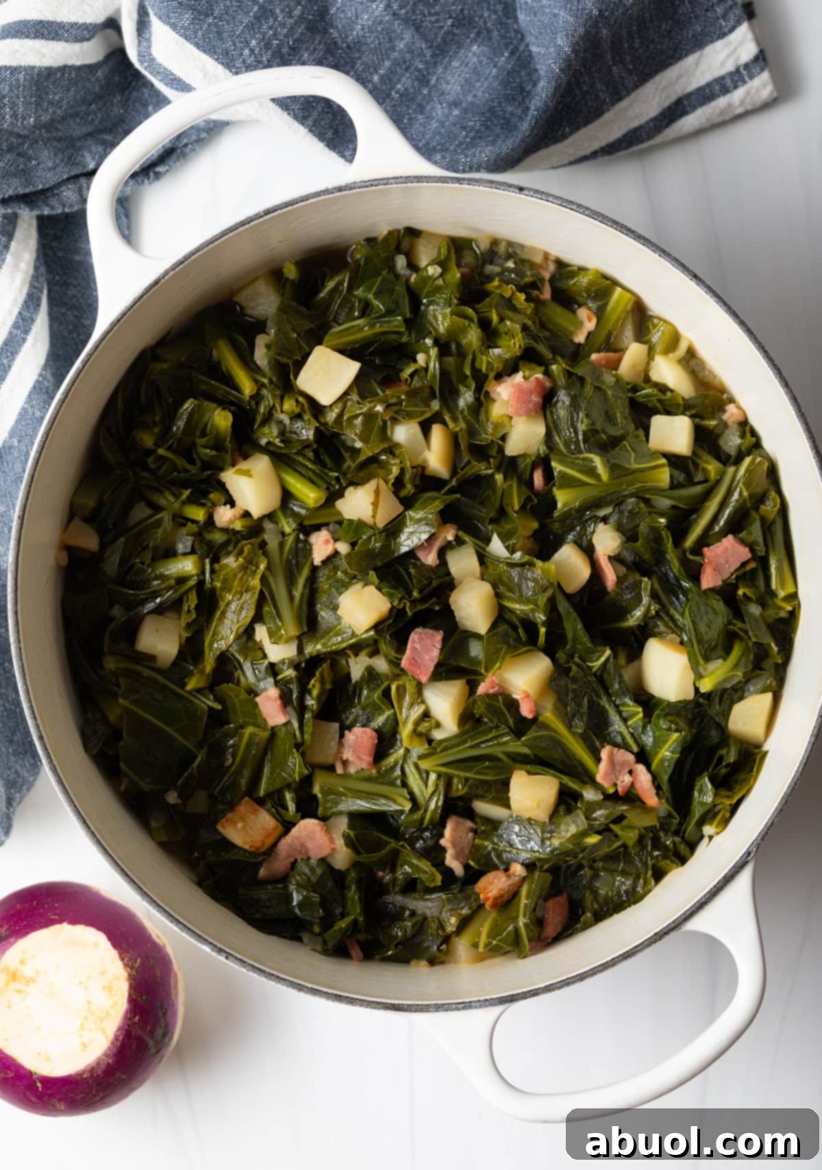 A vibrant overhead shot of spicy collard greens, slow-braised to perfection, served in a rustic Dutch oven. 
